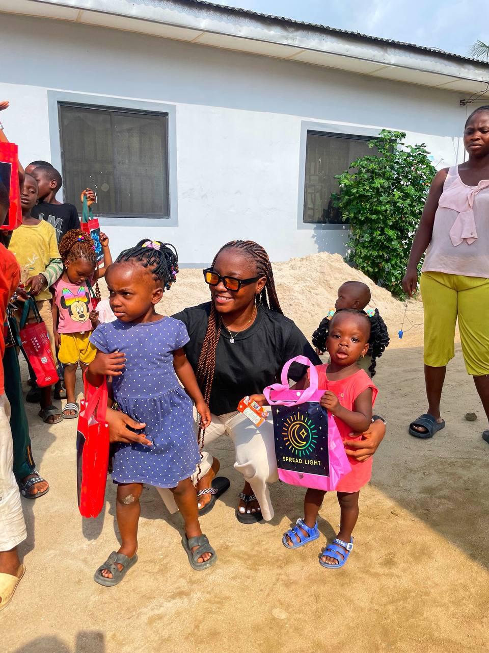 Spread Light volunteer with two young children in Nigeria
